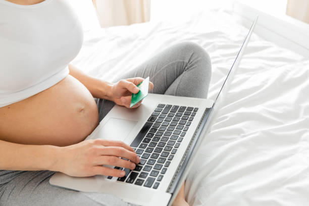 istock Pregnant woman with technology 1300973050