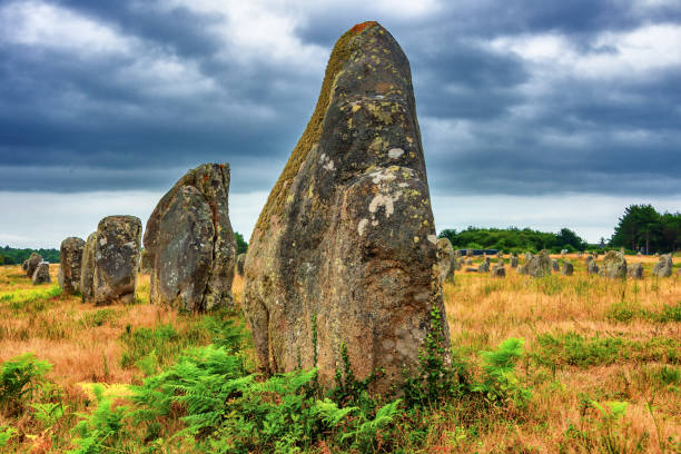 Carnac megaliths alignment in Brittany, France 12.08.2018, view of prehistoric monolith stone alignments in Brittany on rainy summer day.