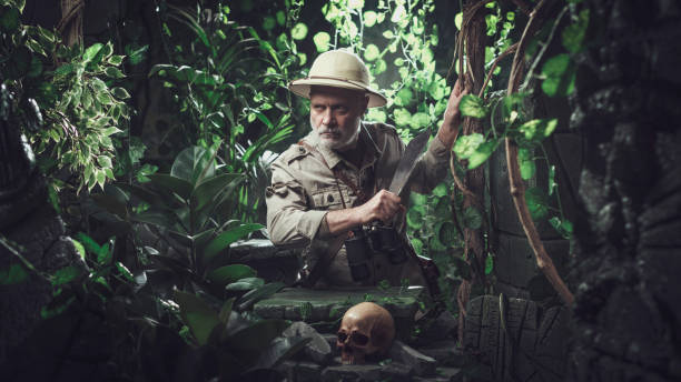 Brave explorer walking in the jungle with a machete Brave explorer walking in the jungle with a machete, he finds a skull and ancient ruins explorer stock pictures, royalty-free photos & images