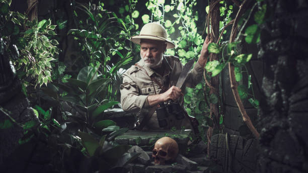 Brave explorer walking in the jungle with a machete Brave explorer walking in the jungle with a machete, he finds a skull and ancient ruins Machete stock pictures, royalty-free photos & images