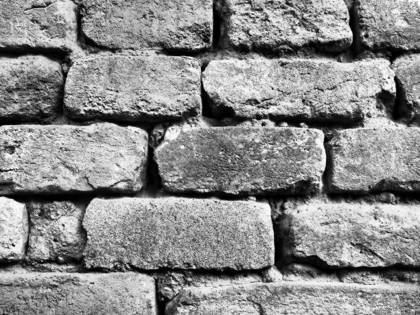 Gray brick wall. Retro and vintage style. High-grain monochrome black and white image.