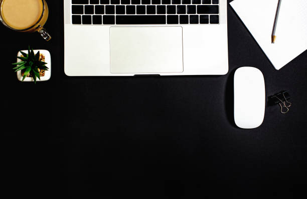 istock top view of laptop on black background 1300974885