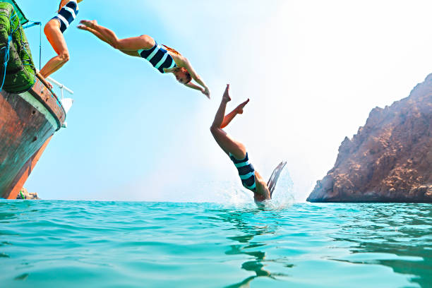 istock Young woman jumping from a sailing boat 1300975443
