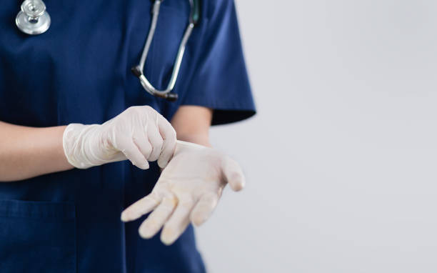 istock Female doctor putting on gloves 1300975473