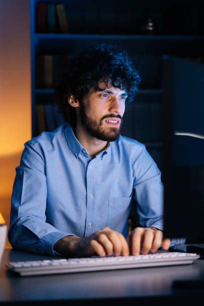 istock Exhausted freelancer watching on monitor, working typing on keyboard and drinking hot coffee. 1300976265