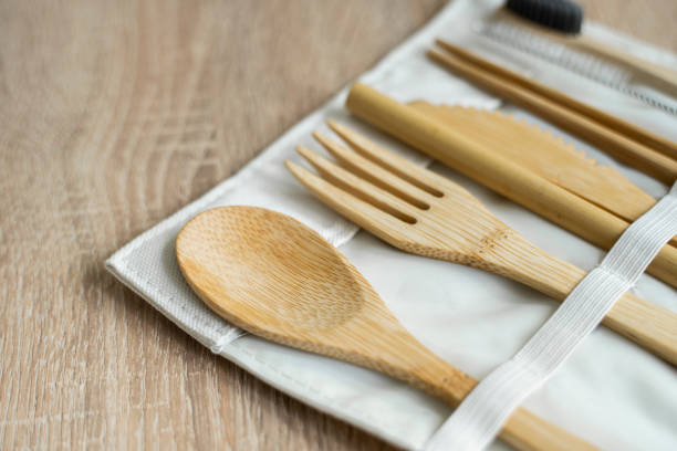 istock Eco friendly bamboo cutlery set in a case on a table. Zero waste concept. Set of bamboo cutlery in a case on a laying on a table. Spoon, fork, knife, toothbrush, tube and chinese sticks. 1300976284