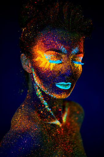 close up uv portrait glowing in a dark female model