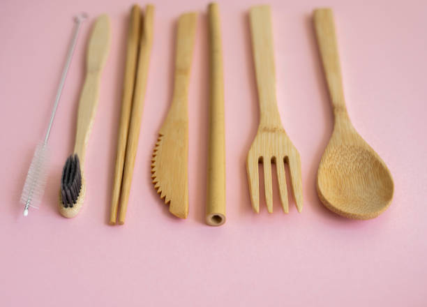 istock Eco friendly bamboo cutlery set in a case on a pink background. Zero waste concept. Set of bamboo cutlery in a case on a laying on a table. Spoon, fork, knife, toothbrush, tube and chinese sticks. 1300978328