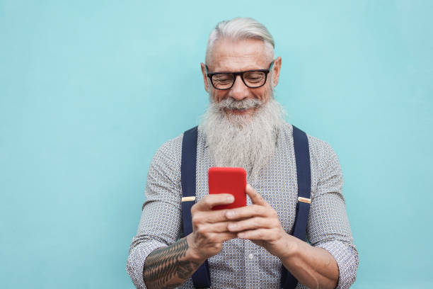 istock Happy senior hipster man using mobile phone outdoors in the city - Focus on face 1300980015