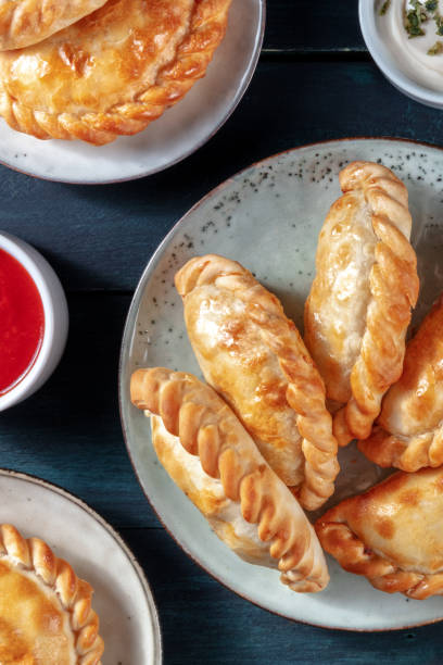 istock Empanadas, shot from above on a dark rustic wooden background 1300980438