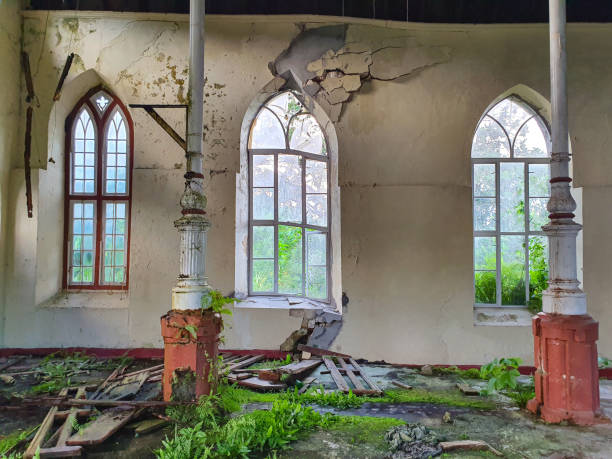 istock CLOSE UP: Windows are broken and facade decays inside an abandoned church. 1300981790