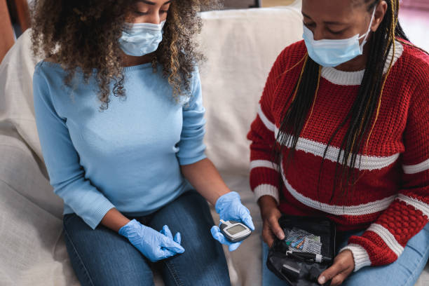 istock Daughter making blood glycemia test for diabetes check during lockdown isolation - Focus on senior woman 1300986520