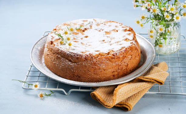 istock Healthy Wholemeal apple cinnamon tea cake on light blue background with copy space. Homemade baked concept. Mother's Day, Birthday Cake card Background. Summer, Spring time recipe. 1300987531