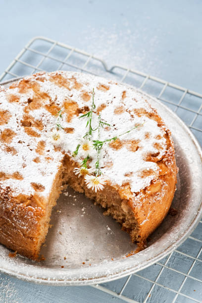 istock Healthy Wholemeal apple cinnamon tea cake on light blue background with copy space. Homemade baked concept. Mother's Day, Birthday Cake card Background. Summer, Spring time recipe. 1300987537