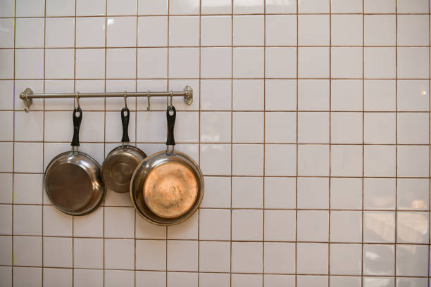 Cooking pan hanging on the kitchen wall after cleaning is complete.
