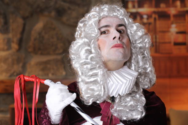 istock Powerful baroque man holding leather whip 1300988255