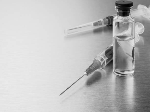 istock Syringes and ampoules on a polished metal background. 1300988488