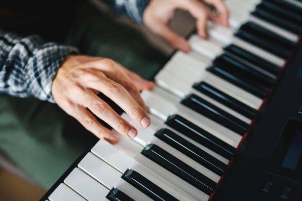 istock Man playing the piano close up photo. 1300991635