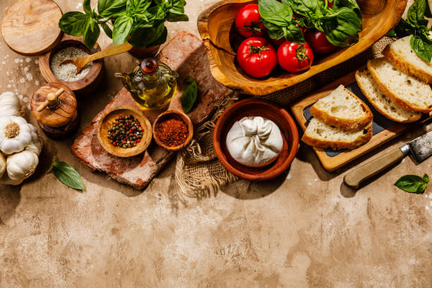 istock Ingredients for Salad with Burrata cheese and Tomatoes on travertine background copy space 1300992489