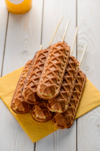 istock Pile of corn dogs on a yellow tissue 1300993313