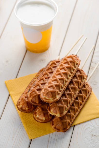 istock Freshly deep-fried corn dogs and a cup of tea with cream foam 1300993329