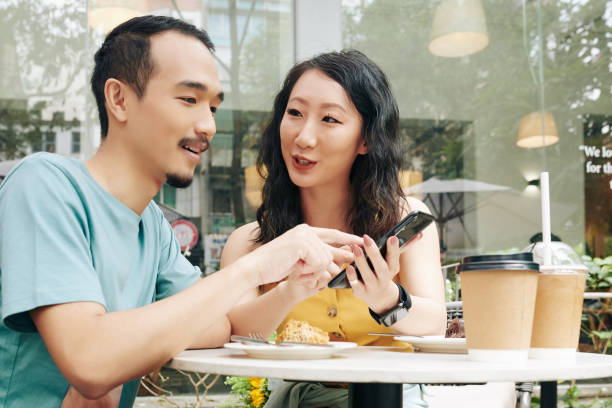 istock Couple discussing photo on smartphone 1300993713