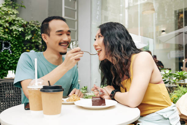 istock Feeding girlfriend with piece of cake 1300993714