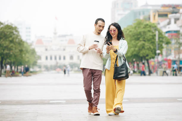 istock Couple walking on city square 1300993773