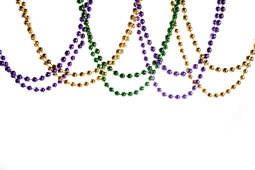 Three colour Merdi gras beads isolated on white background.