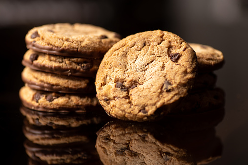Homemade chocolate chip cookies on a table with reflection closeup