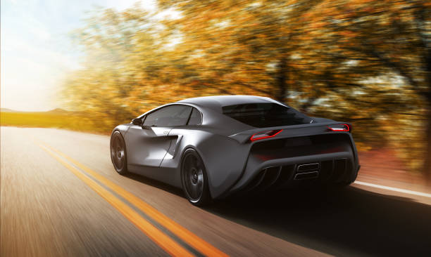 istock grey sportscar driving on a road 1300994247
