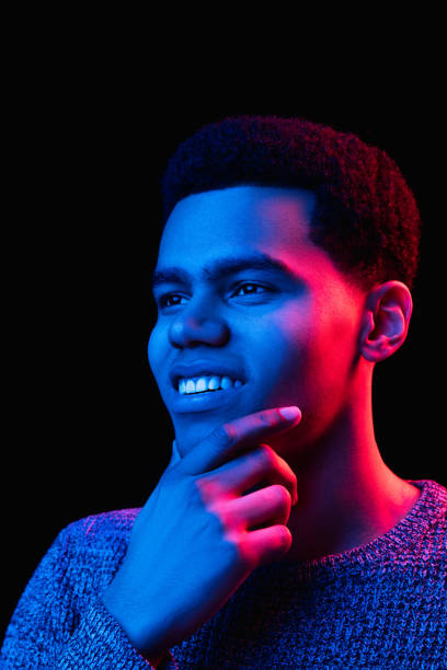 istock African-american man's portrait isolated on black studio background in multicolored neon light 1300994266