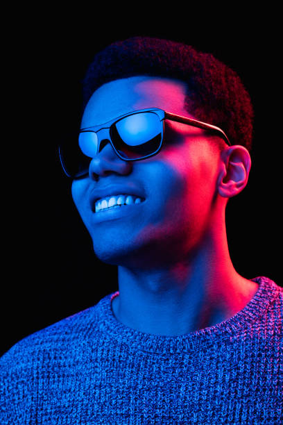 istock African-american man's portrait isolated on black studio background in multicolored neon light 1300994278