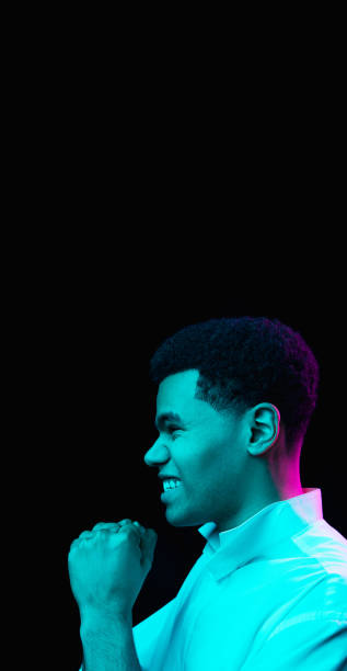 istock African-american man's portrait isolated on black studio background in multicolored neon light 1300994290