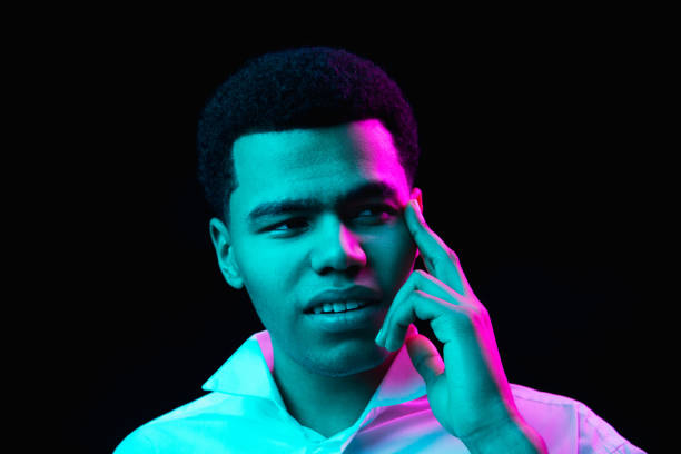 istock African-american man's portrait isolated on black studio background in multicolored neon light 1300994292