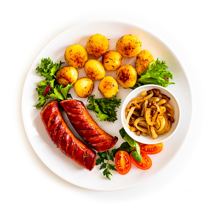 Grilled sausage and vegetables on wooden table