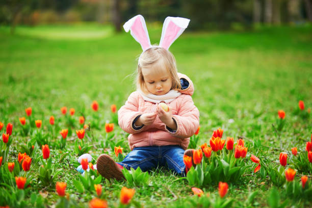 istock Cute little girl playing egg hunt on Easter 1300995413