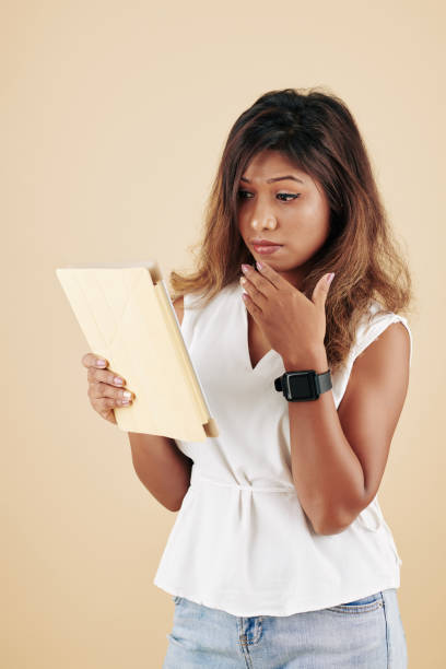 istock Woman reading shocking news 1300995985