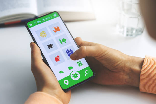 istock woman using mobile phone app to order food delivery 1300996187
