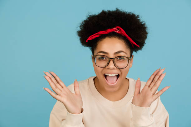 istock African-american woman's portrait isolated on blue studio background with copyspace 1300996330