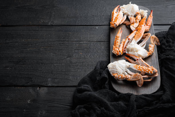istock Boiled blue swimming crab meat, on black wooden table background  , with copyspace  and space for text 1300996423