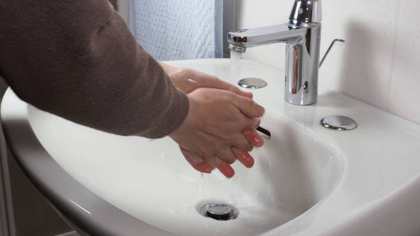 istock Unrecognisable person washing hands 1300997193