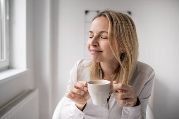 istock Caucasian woman taking coffee break while working in the office 1300998447