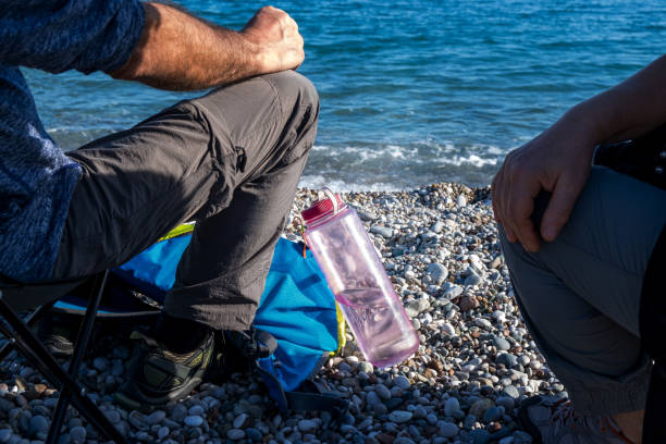 Clear reusable bottle on cliff overlooking valley, great for health, hydration, and zero waste content.