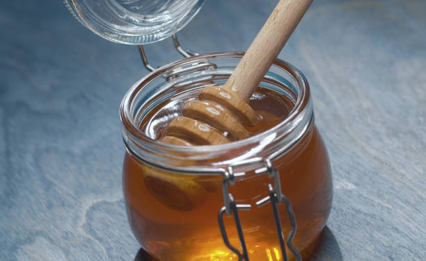 istock Fresh honey in glass jar 1301000489