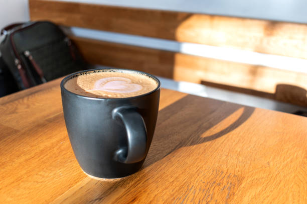 istock There is a black cup with coffee on a wooden table. 1301001900