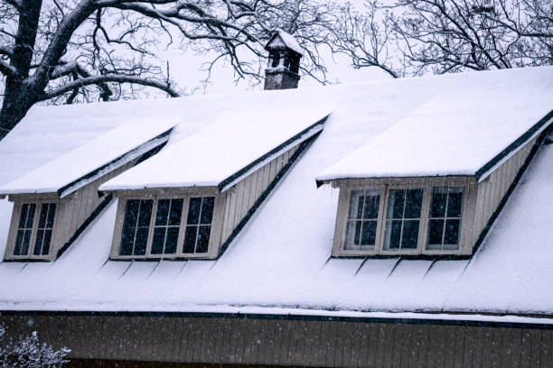 istock White snow is falling on the roof covered with snow. 1301003814