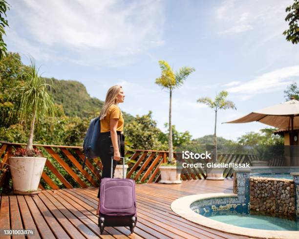 Young Woman Arriving At A Tropical Resort For Her Vacation Stock Photo - Download Image Now