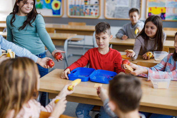 istock Children share their food whit friend in classroom 1301006406