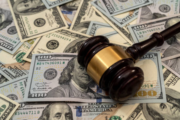 istock Wooden gavel on american dollars bills 1301007348